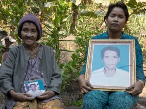 Lav Mech and her daughter Koeuy Leakhena with photos of Angkuoch-maker Mong Koeuy