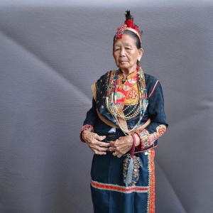Odun Badin, the high priestess (tantagas lawid) of the Lotud of Tuaran wearing her ritual costume with linangkit on the side seam and across the front of her skirt.  (Photo: Judeth John Baptist)
