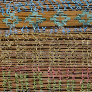 The application of warp ikat – specific sections of threads are bound tightly with a liquid-resistant material to prevent dyes from coloring these sections. Ternate Island, Alor Regency, Indonesia. (Photo: Y. A. Peni)