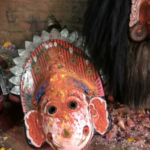 Mask and crown of Ganesha covered with pigment offerings of devotees on display at a local temple, Madhyapur Thimi, Nepal. (Photo: Renuka Gurung)