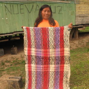 Weaver Debora Pedro displays her hammock. Hand spun, hand woven, natural dyes. Nueva Luz village. (Photo: M. E. del Solar)