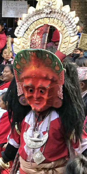 A Banamala dancer wearing the crown, and mask of the goddess Mahakali which is covered in pigment offered by devotees at a local festival, Ganesh Temple, Yecce, Nepal. (Photo: Renuka Gurung)