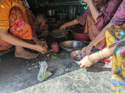 Rohingya women preparing 'Lappachu' a home-made snack made by at kitchen of camp household, Ukhiya, Kutupalong,  Cox’s Bazar, 2023. Photo: Tahura Enam Navile.