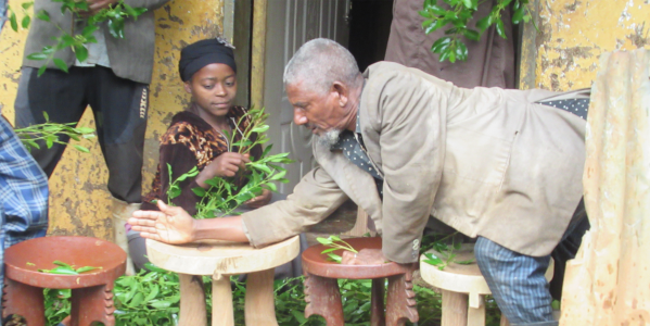 The owner measuring and comparing newly-made stools (Photo: Jira Choroke)