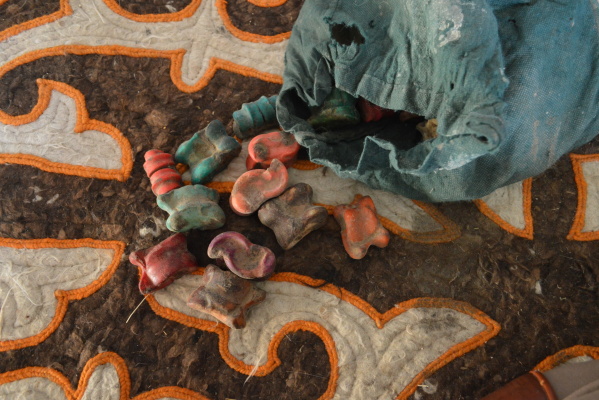 Astragali dyed with the same brilliant colors as felt carpets are used as game pieces. Photo: Kristen Pearson